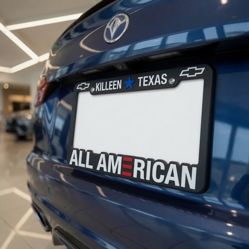 Load image into Gallery viewer, Black custom license plate frame with raised imprint and three-color design, mounted on a car for a personalized look.
