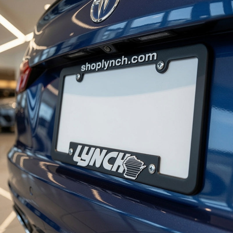 Load image into Gallery viewer, Black custom license plate frame with raised imprint mounted on a car, featuring one-color design for a personalized look.
